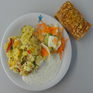 Kartoffelauflauf mit Hirtenkäse und Paprika (15,19), Creme fraiche-Kräuter-Dip (19), kleine Salatgarnitur (9) + 1 Tomate-Mozzarella-Strudel (1,15,19,21,81,83)
