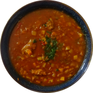 'Deftige Seitansuppe' mit Würzseitan, Paprikastreifen, Rotwein, Kartoffeln und Knoblauch (1,24,44,49,81) dazu Roggenmischbrot (81,82)