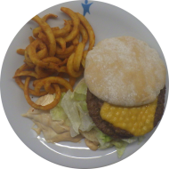 'Double Beef`n Cheese' mit 2 Rinderpattys, Cheddar und Special Sauce (1,2,9,15,19,22,23,52,81) dazu Twister Pommes (81)