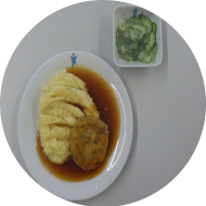 Hausgemachtes Kürbis-Gouda-Medaillon (15,19,81) mit Zwiebelsoße (81) dazu Kartoffel-Buttermilchstampf (19) und kleiner Gurkensalat mit Dill